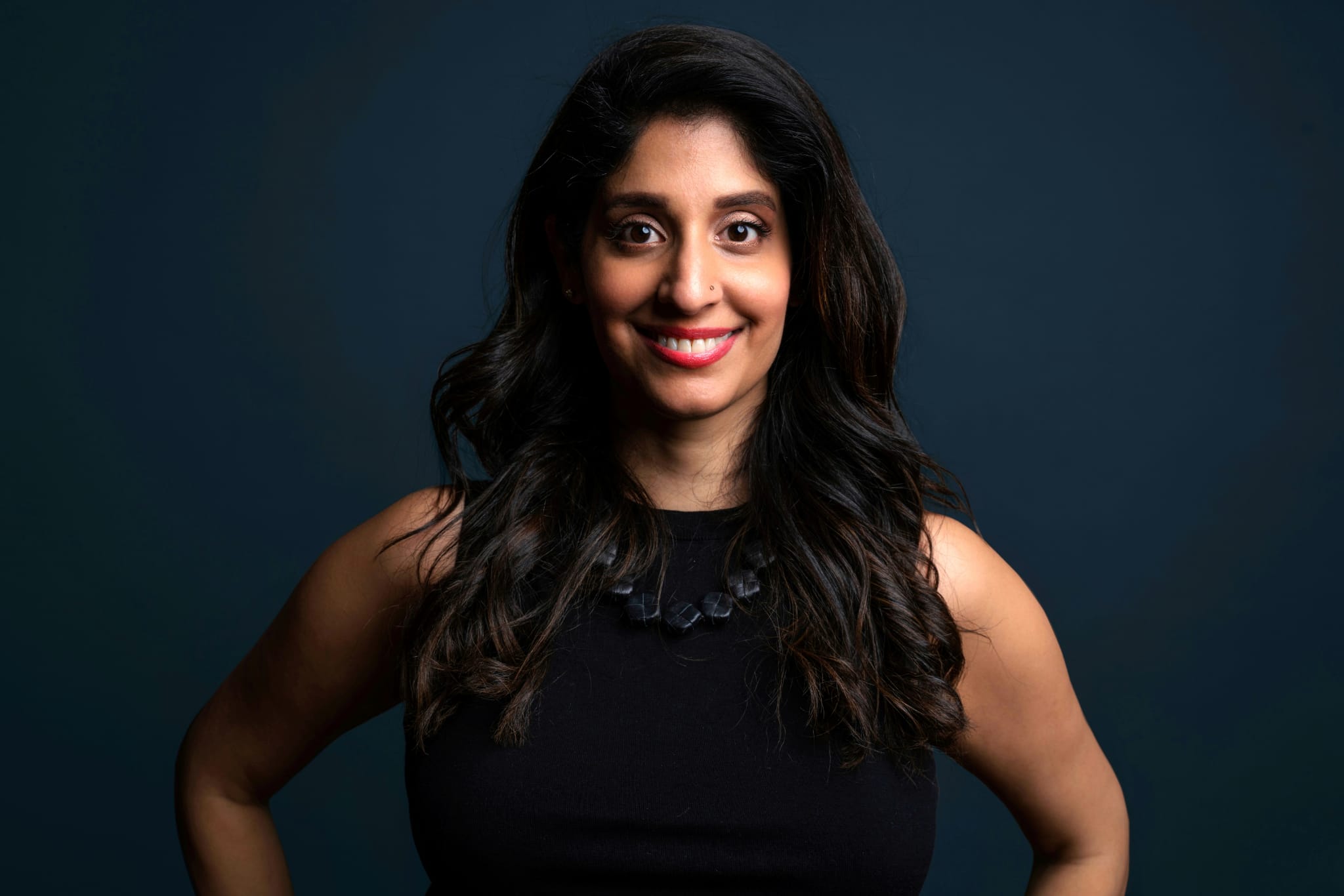 Komal smiling at the camera